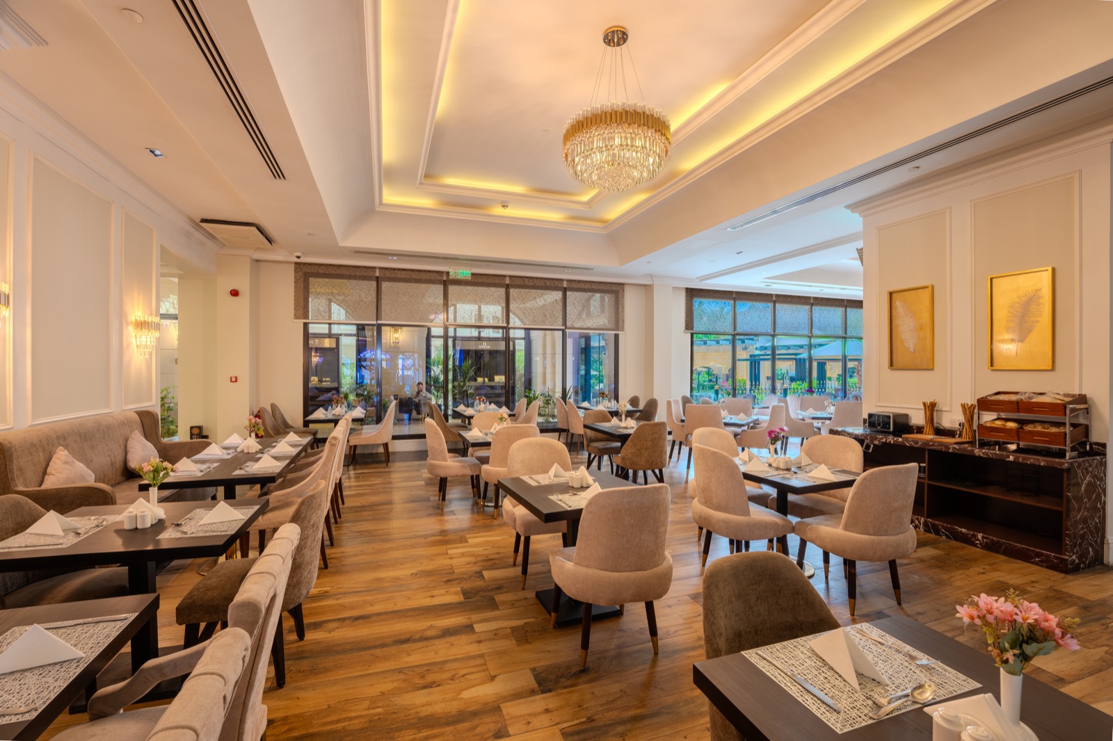 Vittori Restaurant laid for service beneath a crystal chandelier