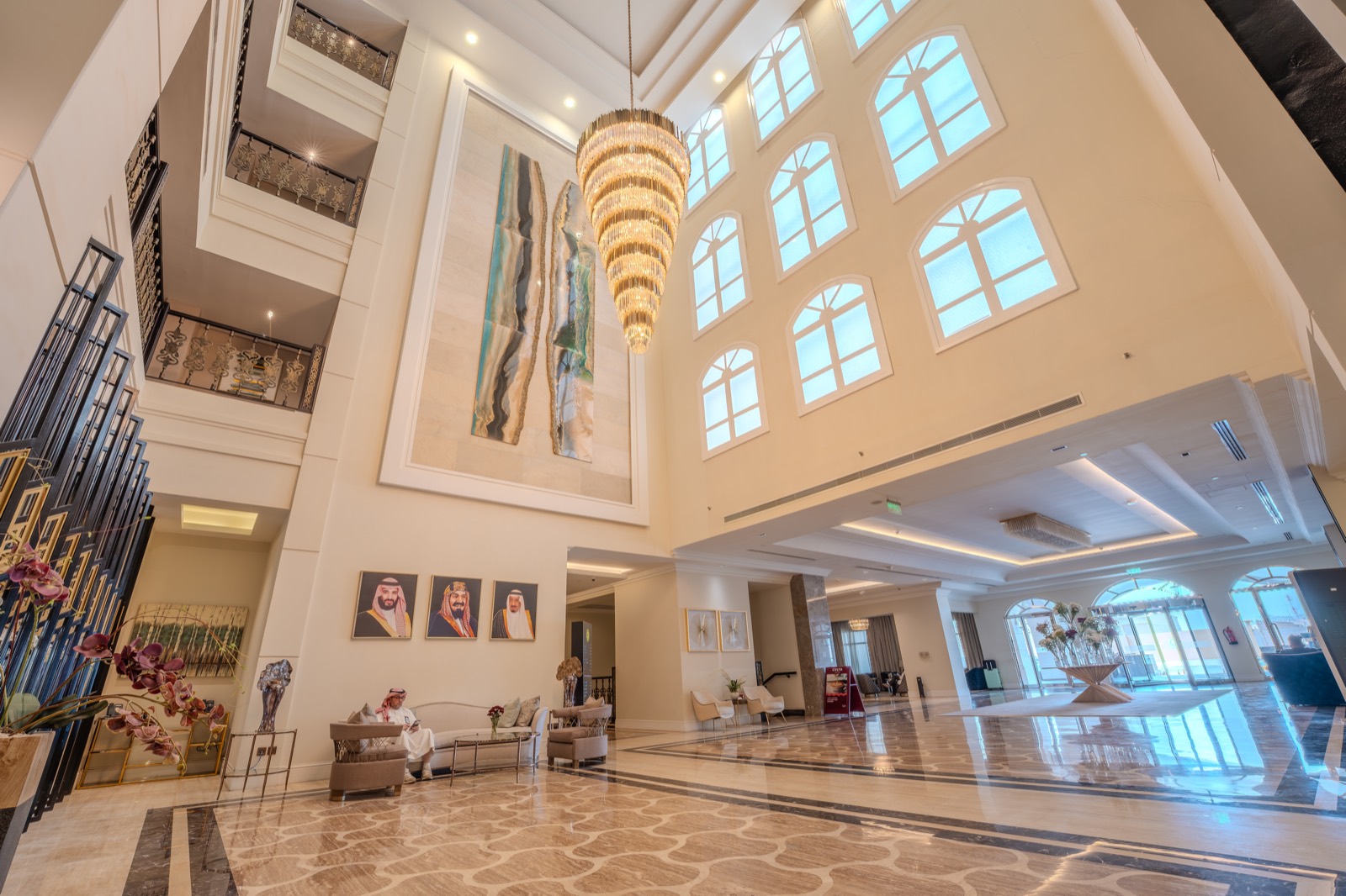 The lobby atrium beneath its chandelier, lit by arched clerestory windows