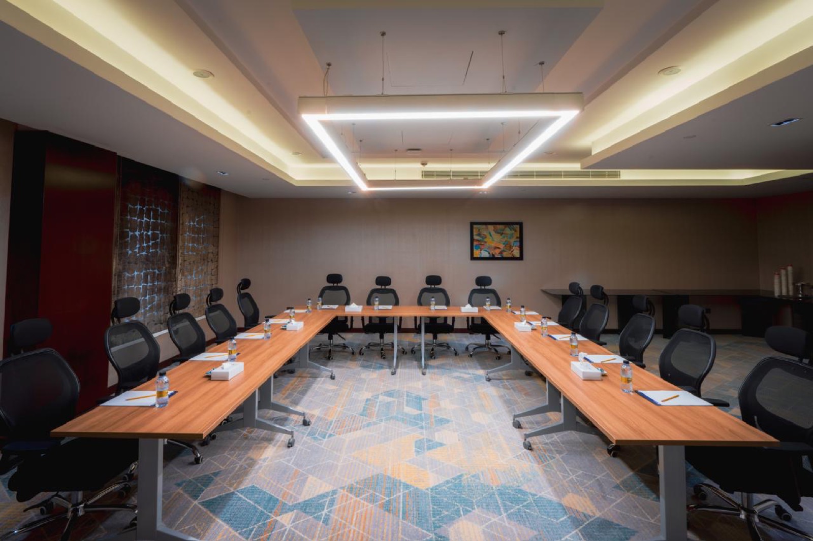 A meeting room set in a U-shape with leather chairs
