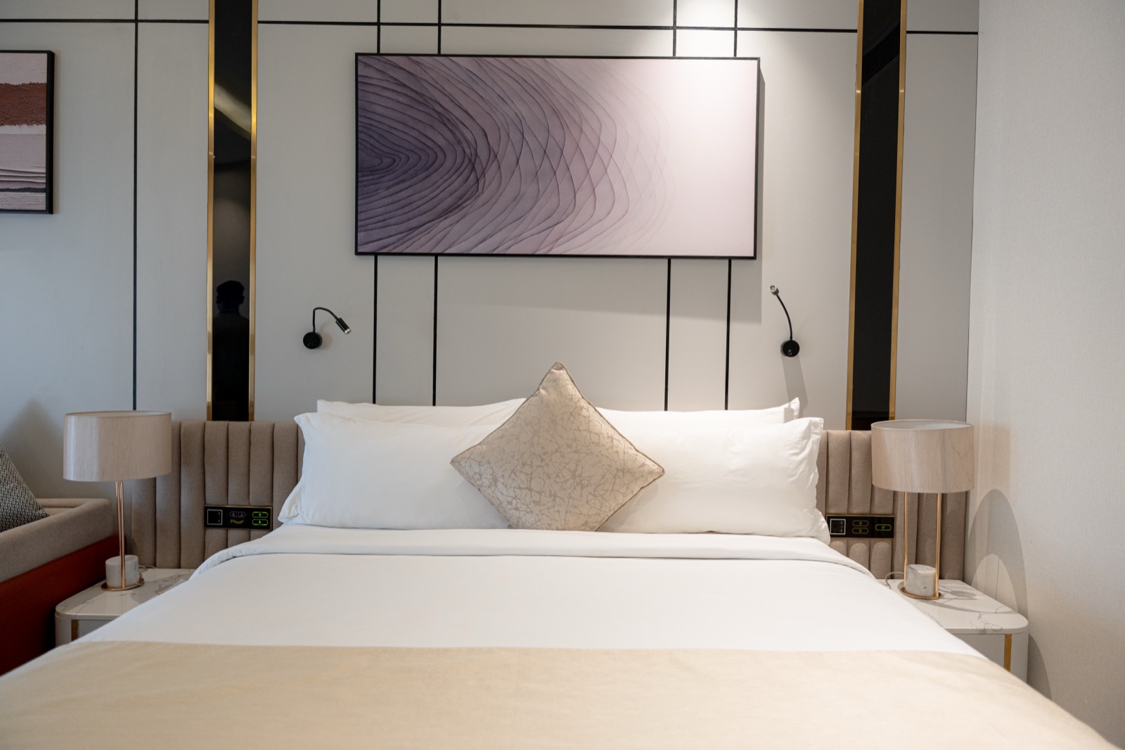 The Superior Room bed beneath its panelled headboard