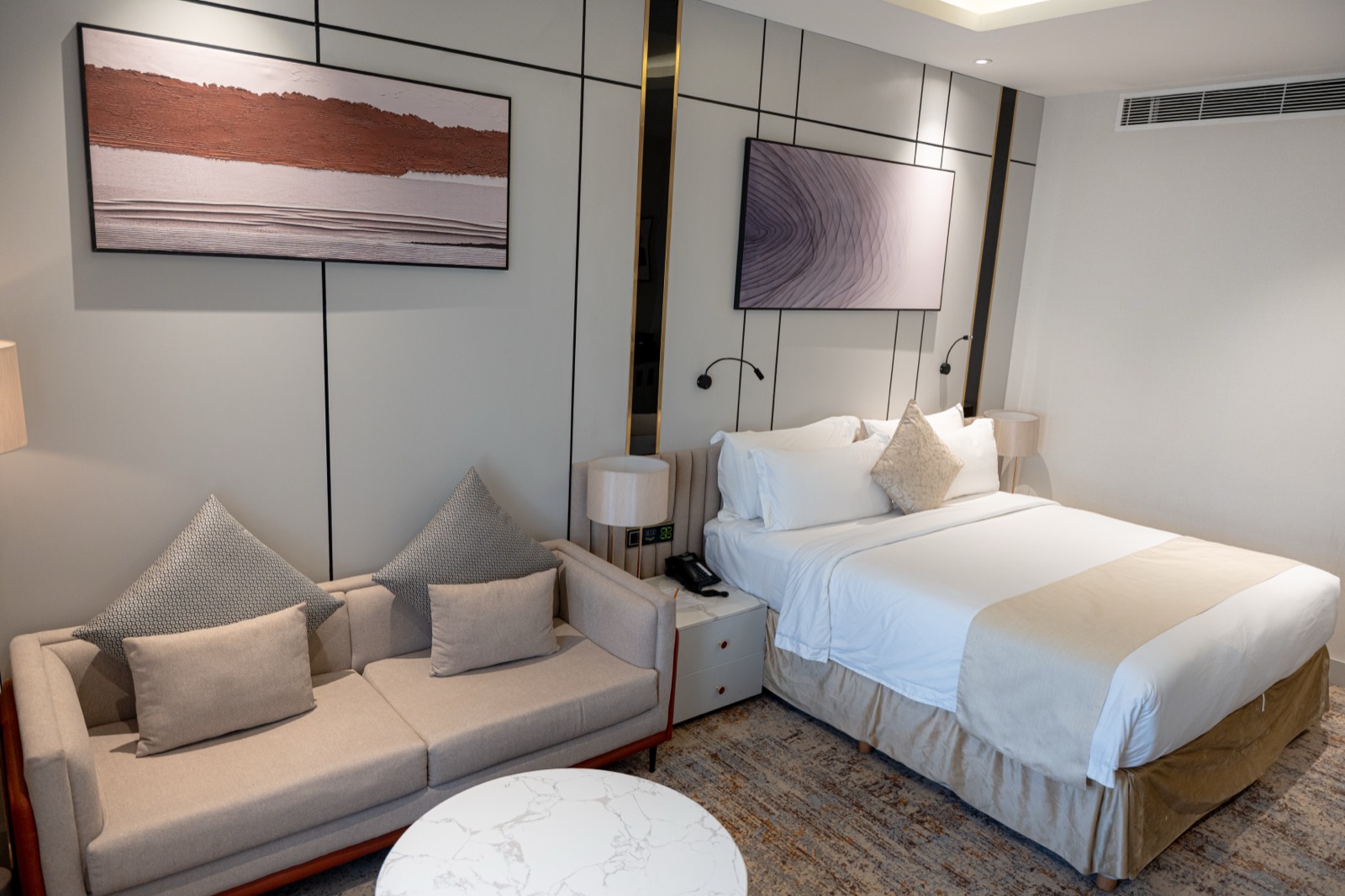 A Superior Room with its own seating corner beside the bed