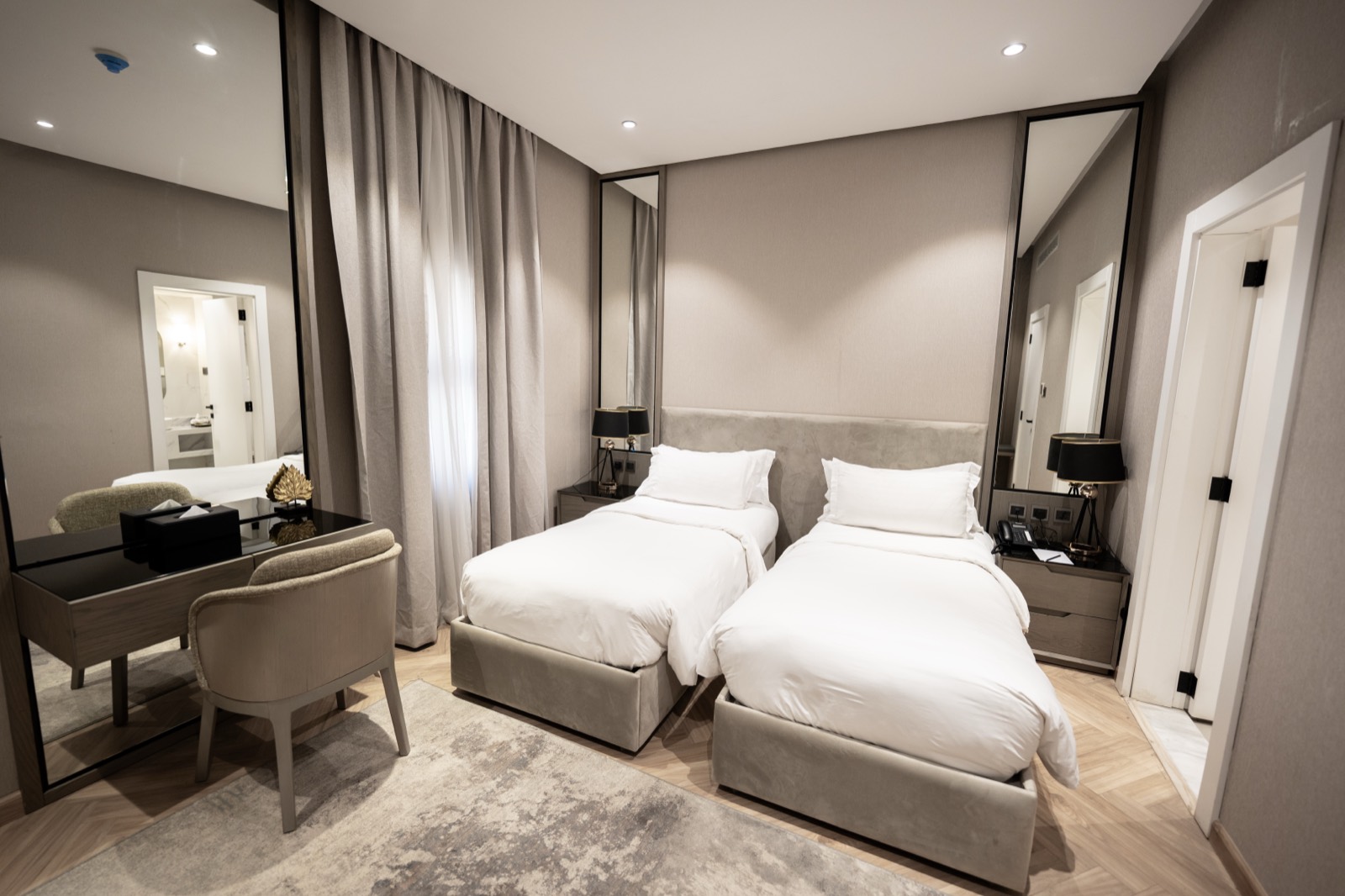 A twin bedroom with its writing desk